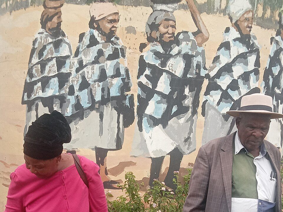 Placeholder: two community elders standing outdoors in Kanye, Botswana